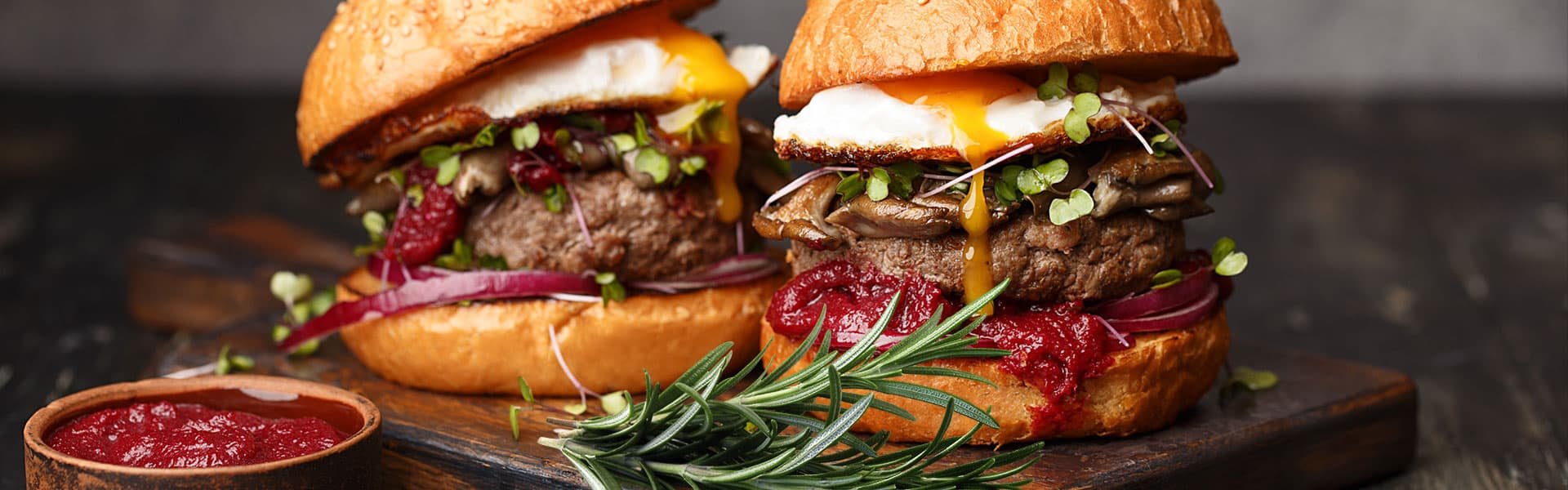 Two burgers with rosemary